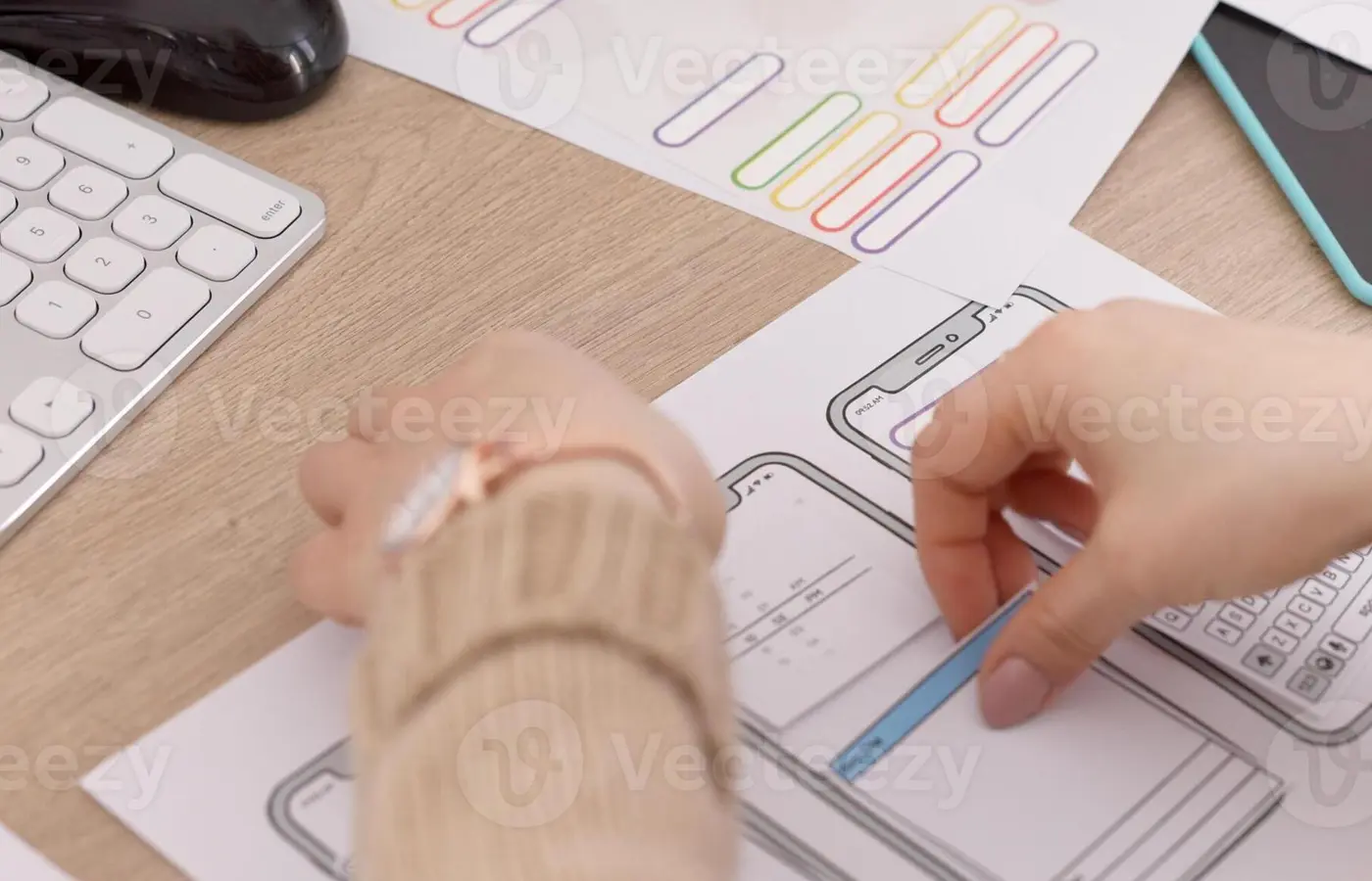 A person organizing planning materials for a mobile application