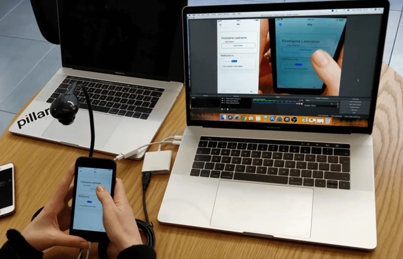 A phone being tested alongside a laptop in a research setting