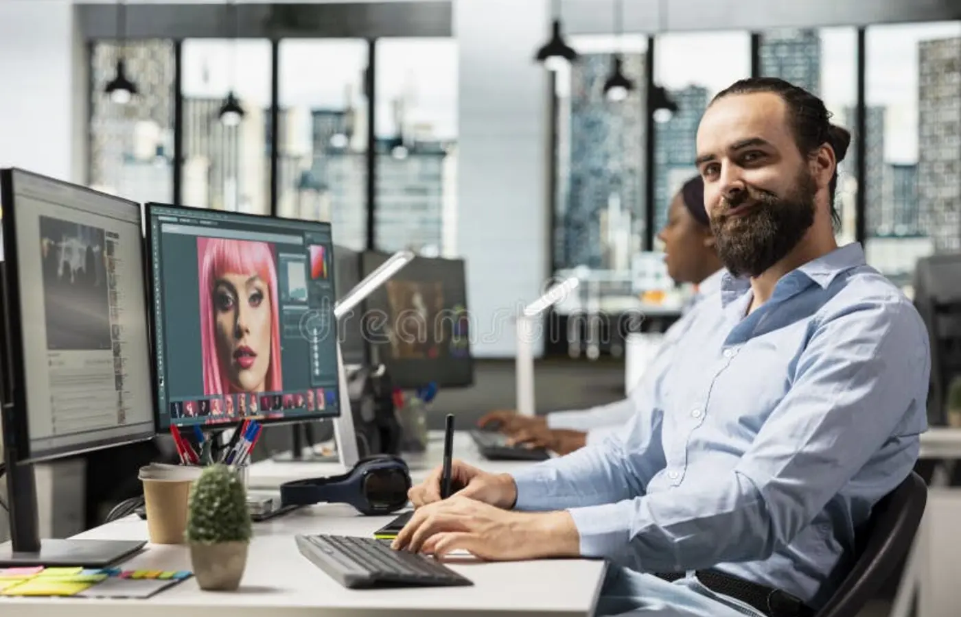 A developer working beside a computer in an office